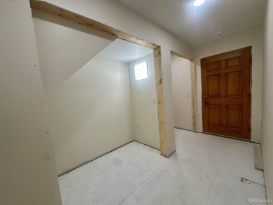 This home offers a rare opportunity to put your own finishing on Escanaba Country Club in Michigan - for sale on GolfHomes.com, golf home, golf lot
