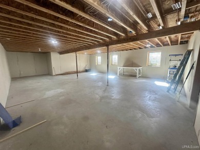 This home offers a rare opportunity to put your own finishing on Escanaba Country Club in Michigan - for sale on GolfHomes.com, golf home, golf lot