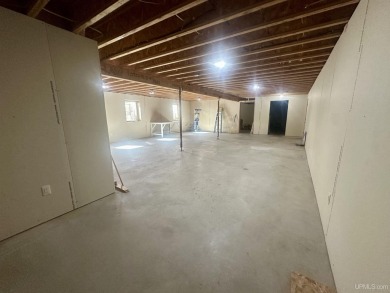 This home offers a rare opportunity to put your own finishing on Escanaba Country Club in Michigan - for sale on GolfHomes.com, golf home, golf lot
