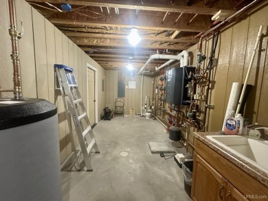 This home offers a rare opportunity to put your own finishing on Escanaba Country Club in Michigan - for sale on GolfHomes.com, golf home, golf lot