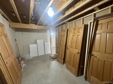 This home offers a rare opportunity to put your own finishing on Escanaba Country Club in Michigan - for sale on GolfHomes.com, golf home, golf lot