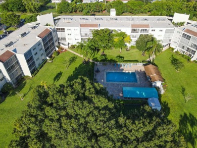 PENTHOUSE VIEWS WELCOME YOU TO  GOLF,POOL & GARDEN VIEWS FROM A on Poinciana Golf Club in Florida - for sale on GolfHomes.com, golf home, golf lot