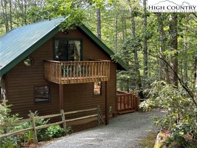 Well-loved mountain home tucked in the woods along the golf on Land Harbor Golf Course in North Carolina - for sale on GolfHomes.com, golf home, golf lot