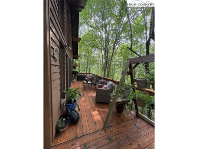 Well-loved mountain home tucked in the woods along the golf on Land Harbor Golf Course in North Carolina - for sale on GolfHomes.com, golf home, golf lot