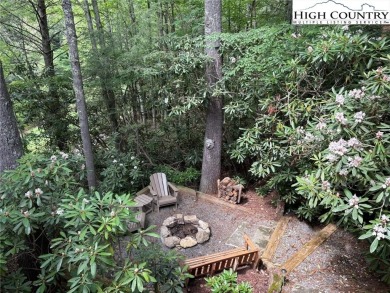 Well-loved mountain home tucked in the woods along the golf on Land Harbor Golf Course in North Carolina - for sale on GolfHomes.com, golf home, golf lot