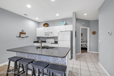 Experience the pinnacle of coastal living in this elegant on Sea Trail Golf Resort in North Carolina - for sale on GolfHomes.com, golf home, golf lot