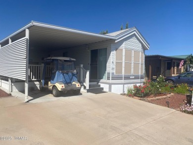 This cozy Park Model features a large front covered deck with a on Juniper Ridge R.V. Golf Resort in Arizona - for sale on GolfHomes.com, golf home, golf lot