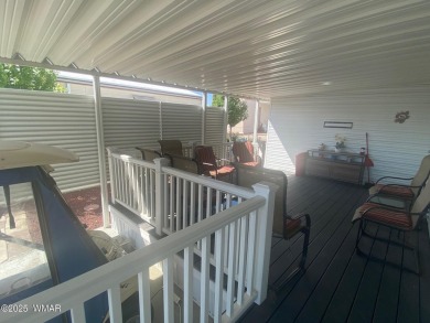 This cozy Park Model features a large front covered deck with a on Juniper Ridge R.V. Golf Resort in Arizona - for sale on GolfHomes.com, golf home, golf lot