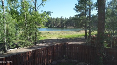 Discover timeless elegance and serene lake views in this on Pinetop Lakes Country Club in Arizona - for sale on GolfHomes.com, golf home, golf lot