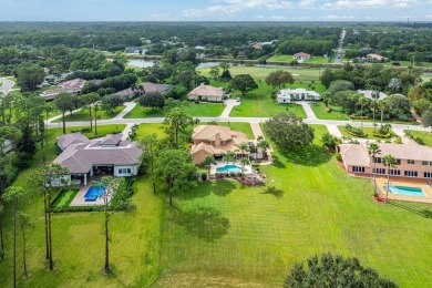 Spacious 5-bedroom, 4-bath, two-story home on a 1-acre lot in on PGA National Estates Golf Course in Florida - for sale on GolfHomes.com, golf home, golf lot