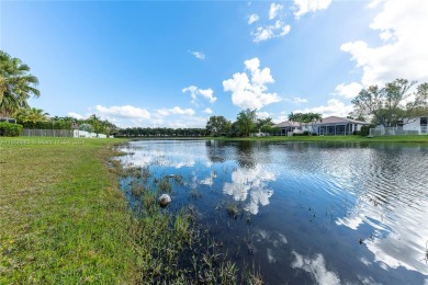 GORGEOUS LAKE FRONT HOME IN THE HIGHLY DESIRABLE GATED COMMUNITY on Weston Hills Country Club in Florida - for sale on GolfHomes.com, golf home, golf lot