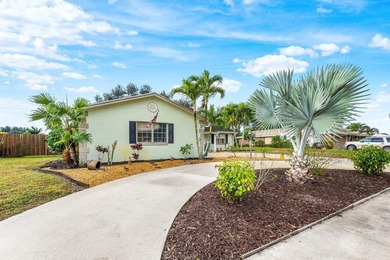 Enjoy easy Florida living in this well-cared-for 3-bedroom on Palm Beach National Golf and Country Club in Florida - for sale on GolfHomes.com, golf home, golf lot
