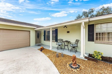 Enjoy easy Florida living in this well-cared-for 3-bedroom on Palm Beach National Golf and Country Club in Florida - for sale on GolfHomes.com, golf home, golf lot