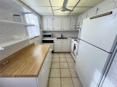 ***CORNER CONDO*** WELL MAINTAINED FIRST FLOOR,  2 BEDROOM, 1.5 on Hillsboro Pines Golf in Florida - for sale on GolfHomes.com, golf home, golf lot