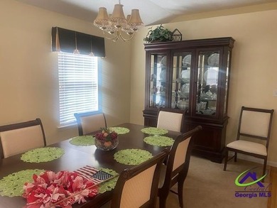 Enjoy the lovely view of the golf course from the screened-in on Houston Springs Resort and Golf Course in Georgia - for sale on GolfHomes.com, golf home, golf lot