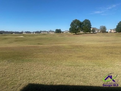 Enjoy the lovely view of the golf course from the screened-in on Houston Springs Resort and Golf Course in Georgia - for sale on GolfHomes.com, golf home, golf lot