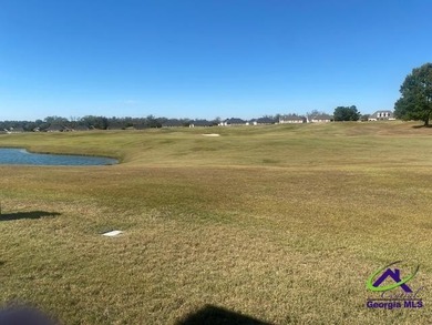 Enjoy the lovely view of the golf course from the screened-in on Houston Springs Resort and Golf Course in Georgia - for sale on GolfHomes.com, golf home, golf lot