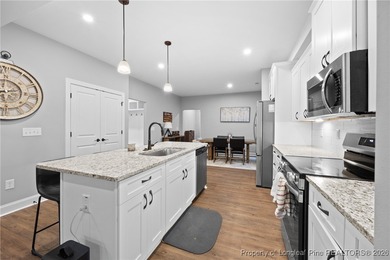 Welcome home to this well-maintained 4-bedroom, 2.5-bath on Woodlake Country Club in North Carolina - for sale on GolfHomes.com, golf home, golf lot