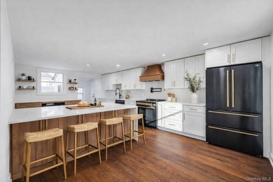 Set on a rare double lot in the Nassau Shores section of East on Peninsula Golf Club in New York - for sale on GolfHomes.com, golf home, golf lot