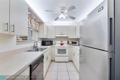 Lovely light and bright first floor corner unit overlooking the on Deer Creek Golf Club in Florida - for sale on GolfHomes.com, golf home, golf lot