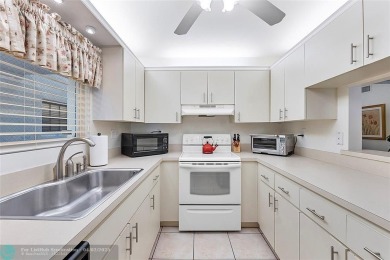 Lovely light and bright first floor corner unit overlooking the on Deer Creek Golf Club in Florida - for sale on GolfHomes.com, golf home, golf lot