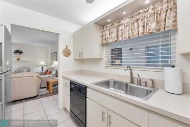 Lovely light and bright first floor corner unit overlooking the on Deer Creek Golf Club in Florida - for sale on GolfHomes.com, golf home, golf lot