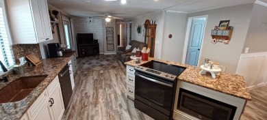 Come settle down and relax in a beautiful, manufactured home on Fairways Country Club in Florida - for sale on GolfHomes.com, golf home, golf lot