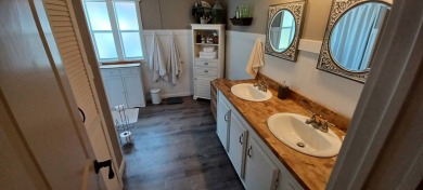 Come settle down and relax in a beautiful, manufactured home on Fairways Country Club in Florida - for sale on GolfHomes.com, golf home, golf lot