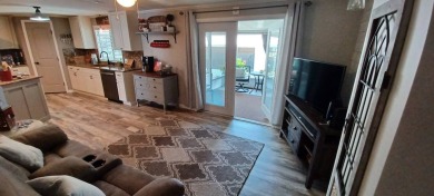 Come settle down and relax in a beautiful, manufactured home on Fairways Country Club in Florida - for sale on GolfHomes.com, golf home, golf lot