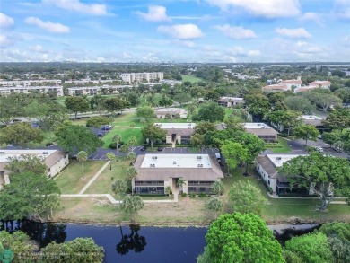 Lovely light and bright first floor corner unit overlooking the on Deer Creek Golf Club in Florida - for sale on GolfHomes.com, golf home, golf lot