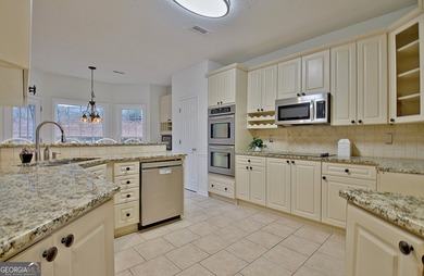 Welcome to this warm and inviting home in the beloved Planterra on Canongate At Planterra Ridge in Georgia - for sale on GolfHomes.com, golf home, golf lot