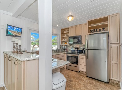 Welcome to this charming 3 BR, 3 Bath coastal retreat located in on Beachwood Golf Club in South Carolina - for sale on GolfHomes.com, golf home, golf lot