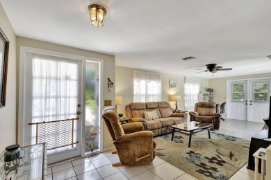 This Mediterranean home sits on a corner lot in the northern end on Lake Worth Municipal Golf Course in Florida - for sale on GolfHomes.com, golf home, golf lot