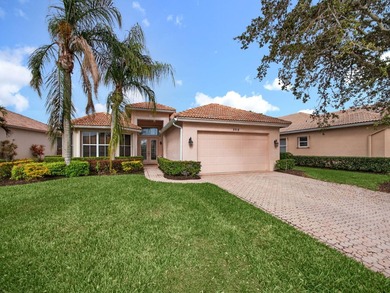 Beautifully designed and ideally situated on the lake, this on PGA Golf Club in PGA Village in Florida - for sale on GolfHomes.com, golf home, golf lot