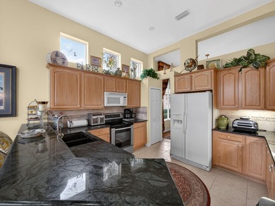 Beautifully designed and ideally situated on the lake, this on PGA Golf Club in PGA Village in Florida - for sale on GolfHomes.com, golf home, golf lot