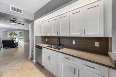 Wake up to peaceful water views and end your evenings surrounded on Wynmoor Golf Course in Florida - for sale on GolfHomes.com, golf home, golf lot