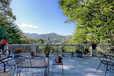 A Wrap Around Covered Porch, full of beautiful plants, welcomes on Sky Valley Resort and Country Club in Georgia - for sale on GolfHomes.com, golf home, golf lot