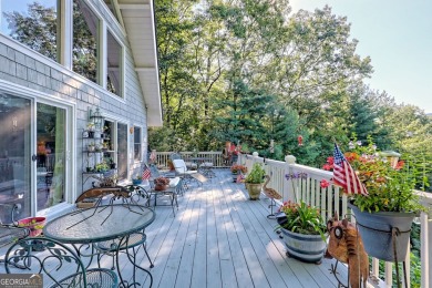 A Wrap Around Covered Porch, full of beautiful plants, welcomes on Sky Valley Resort and Country Club in Georgia - for sale on GolfHomes.com, golf home, golf lot