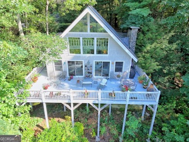A Wrap Around Covered Porch, full of beautiful plants, welcomes on Sky Valley Resort and Country Club in Georgia - for sale on GolfHomes.com, golf home, golf lot