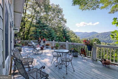 A Wrap Around Covered Porch, full of beautiful plants, welcomes on Sky Valley Resort and Country Club in Georgia - for sale on GolfHomes.com, golf home, golf lot