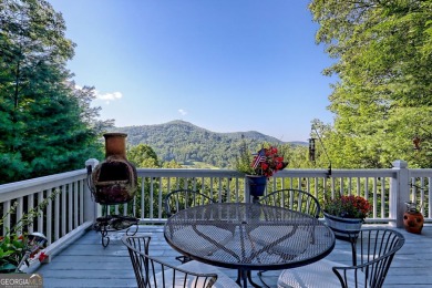A Wrap Around Covered Porch, full of beautiful plants, welcomes on Sky Valley Resort and Country Club in Georgia - for sale on GolfHomes.com, golf home, golf lot