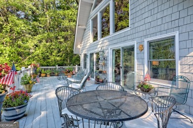 A Wrap Around Covered Porch, full of beautiful plants, welcomes on Sky Valley Resort and Country Club in Georgia - for sale on GolfHomes.com, golf home, golf lot