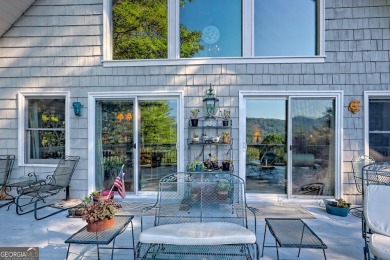 A Wrap Around Covered Porch, full of beautiful plants, welcomes on Sky Valley Resort and Country Club in Georgia - for sale on GolfHomes.com, golf home, golf lot