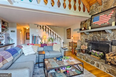 A Wrap Around Covered Porch, full of beautiful plants, welcomes on Sky Valley Resort and Country Club in Georgia - for sale on GolfHomes.com, golf home, golf lot