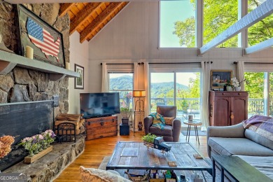 A Wrap Around Covered Porch, full of beautiful plants, welcomes on Sky Valley Resort and Country Club in Georgia - for sale on GolfHomes.com, golf home, golf lot