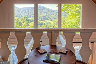 A Wrap Around Covered Porch, full of beautiful plants, welcomes on Sky Valley Resort and Country Club in Georgia - for sale on GolfHomes.com, golf home, golf lot