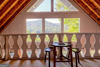 A Wrap Around Covered Porch, full of beautiful plants, welcomes on Sky Valley Resort and Country Club in Georgia - for sale on GolfHomes.com, golf home, golf lot