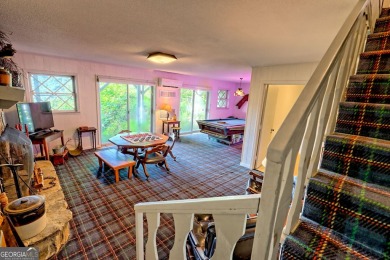 A Wrap Around Covered Porch, full of beautiful plants, welcomes on Sky Valley Resort and Country Club in Georgia - for sale on GolfHomes.com, golf home, golf lot