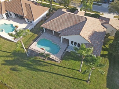 This former model home offers breathtaking lake and golf course on The Wanderers Club in Florida - for sale on GolfHomes.com, golf home, golf lot