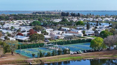 Live the vacation every single day in vibrant Barefoot Bay! This on Barefoot Bay Golf Course in Florida - for sale on GolfHomes.com, golf home, golf lot